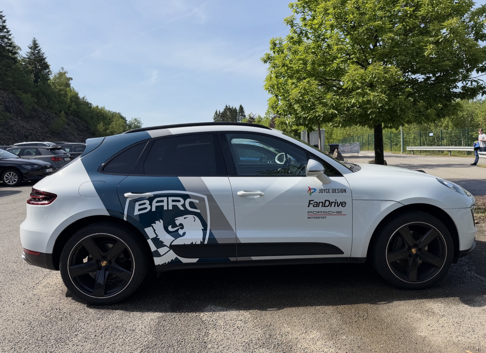 A BARC-liveried Porsche Macan course car carrying FanDrive branding at a circuit