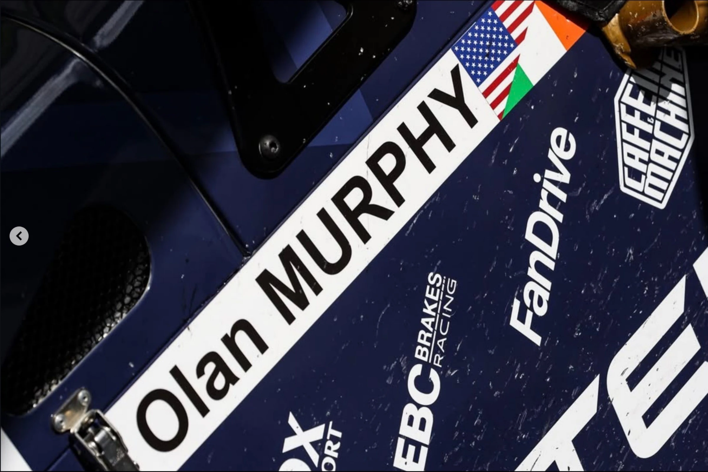 A close-up of the car livery showing the FanDrive sponsor decal among the driver and partner names.